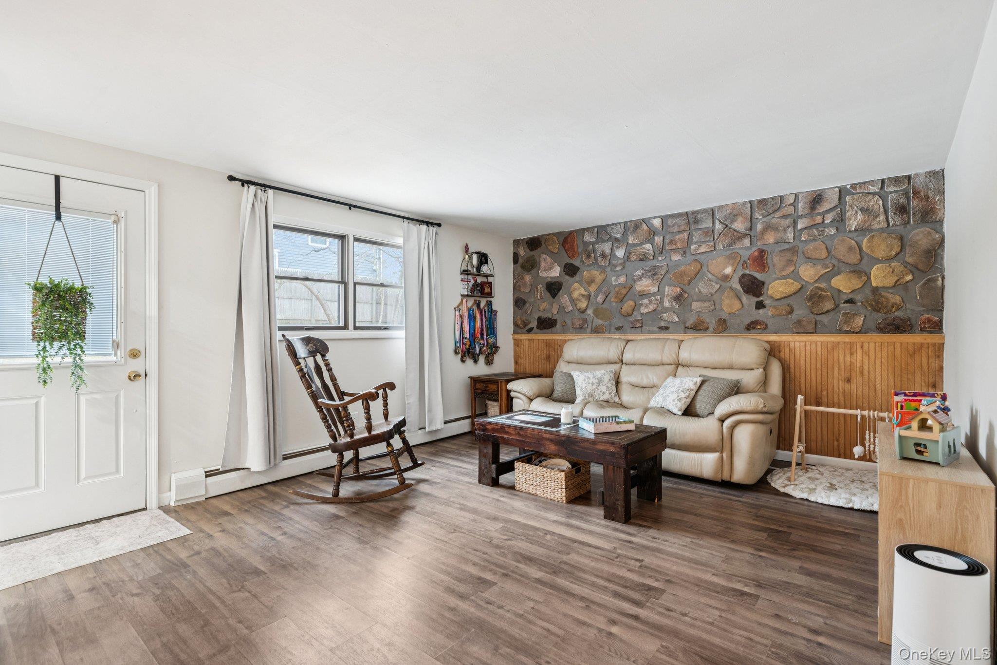 25 Wilson Street Centereach, NY 11720 - Photo 13 of 27 a living room with furniture and a wooden floor
