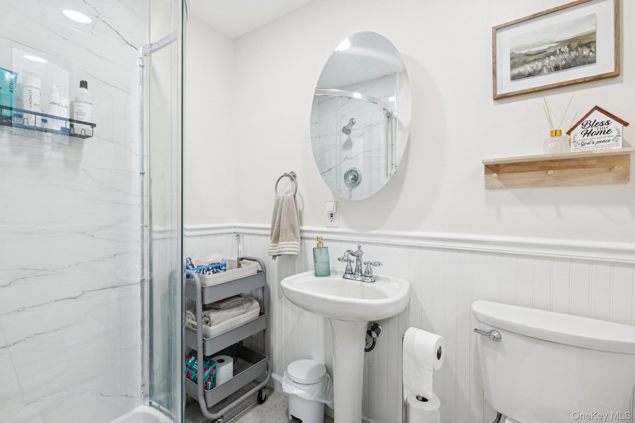 25 Wilson Street Centereach, NY 11720 - Photo 15 of 27 a bathroom with a sink a toilet and a mirror