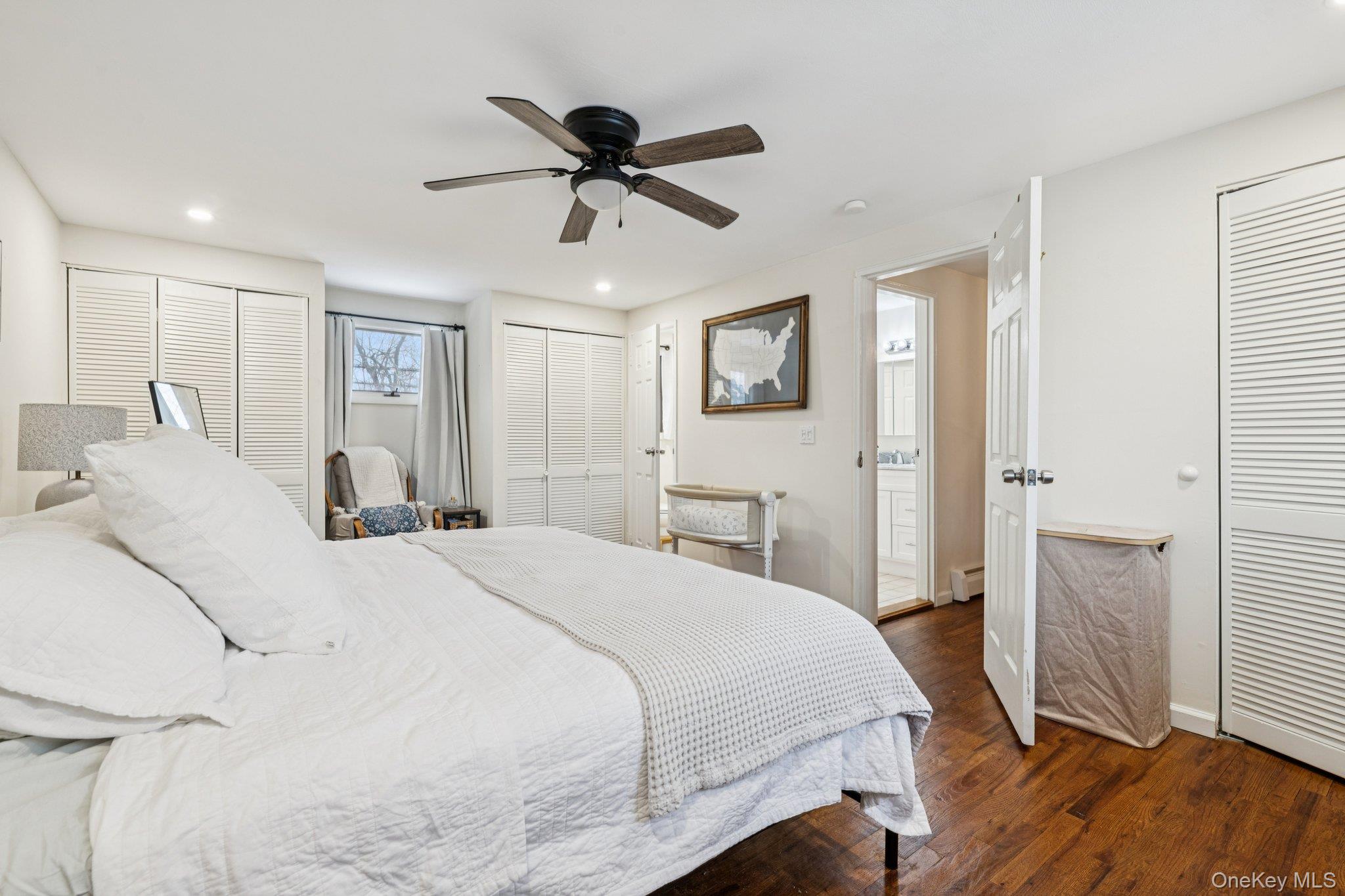 25 Wilson Street Centereach, NY 11720 - Photo 17 of 27 a bedroom with a bed and a chandelier