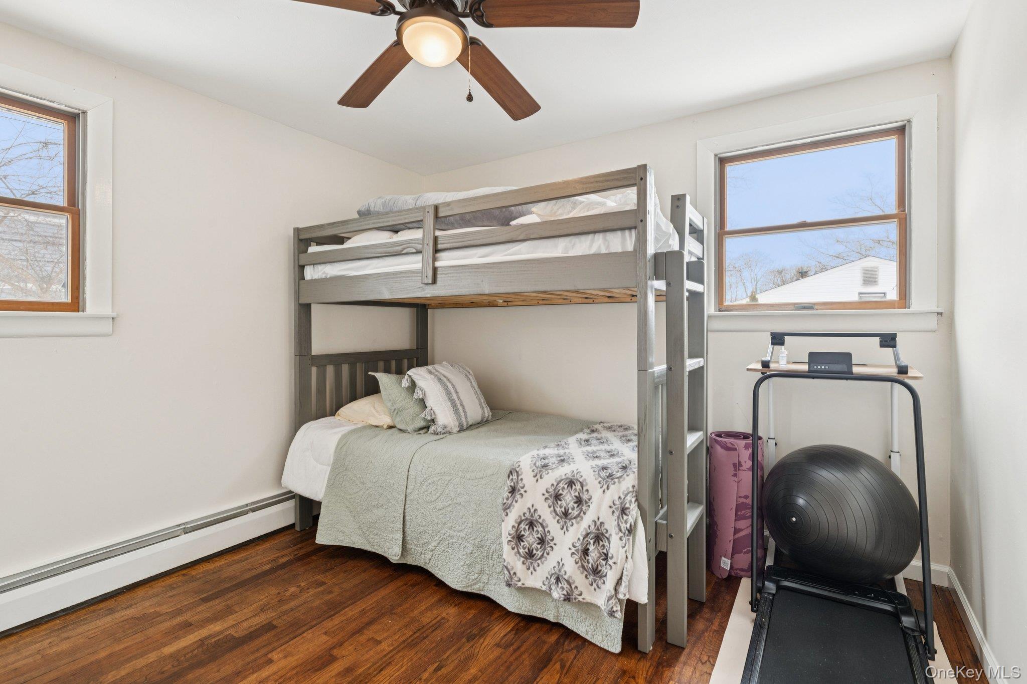 25 Wilson Street Centereach, NY 11720 - Photo 21 of 27 a bedroom with a bed and wooden floor