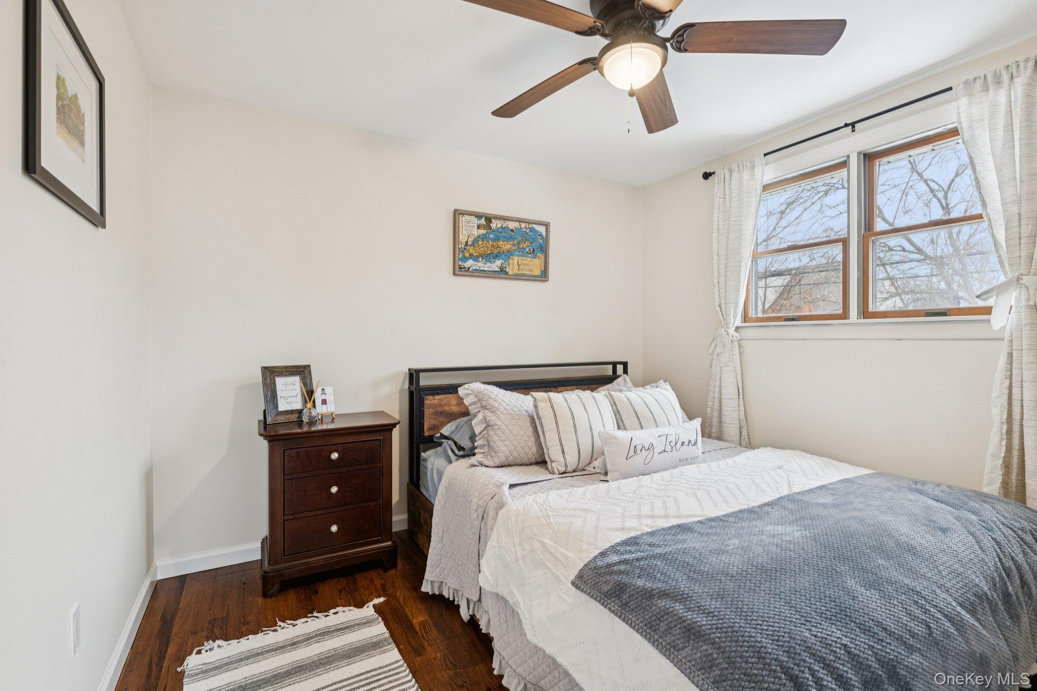 25 Wilson Street Centereach, NY 11720 - Photo 22 of 27 a bedroom with a bed and a window
