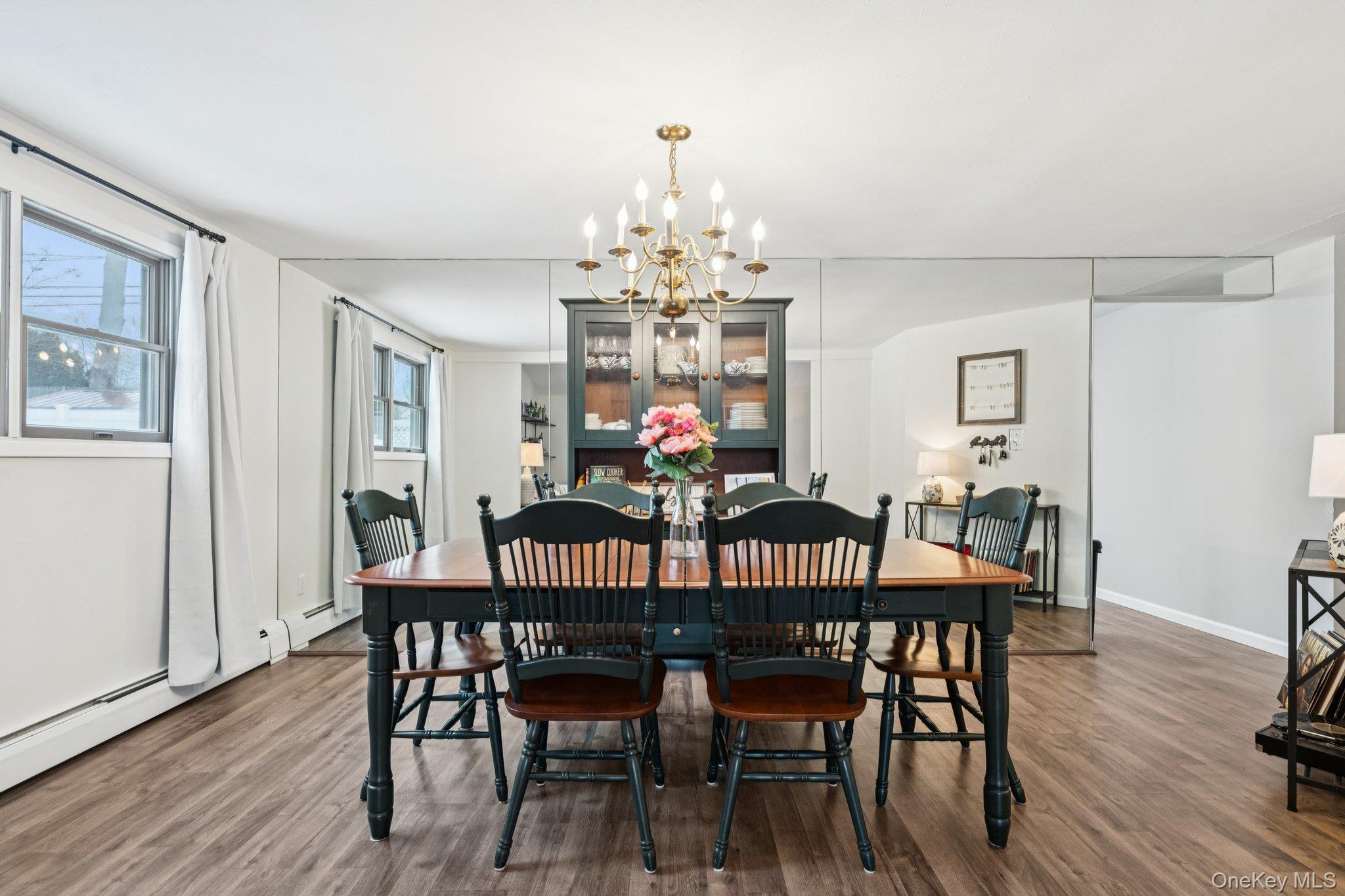 25 Wilson Street Centereach, NY 11720 - Photo 7 of 27 a view of a dining room with furniture wooden floor and chandelier
