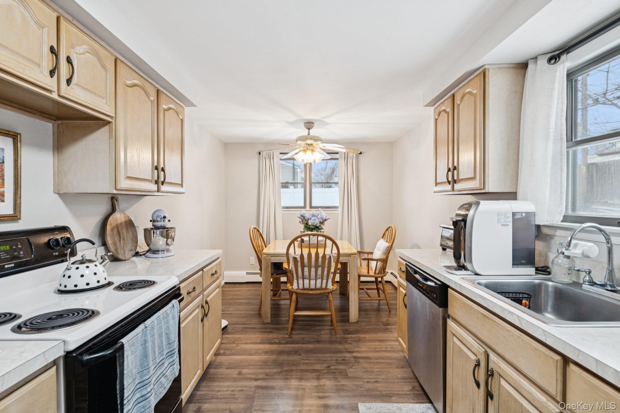 25 Wilson Street Centereach, NY 11720 - Photo 10 of 27 a kitchen with granite countertop a sink stove and cabinets