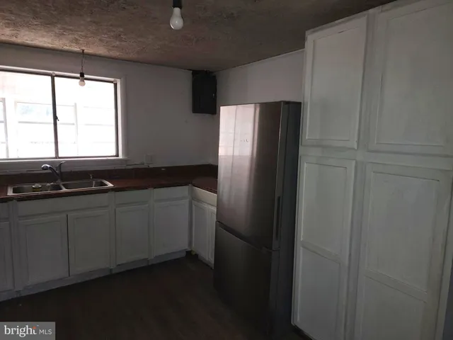 a kitchen with a sink and a refrigerator