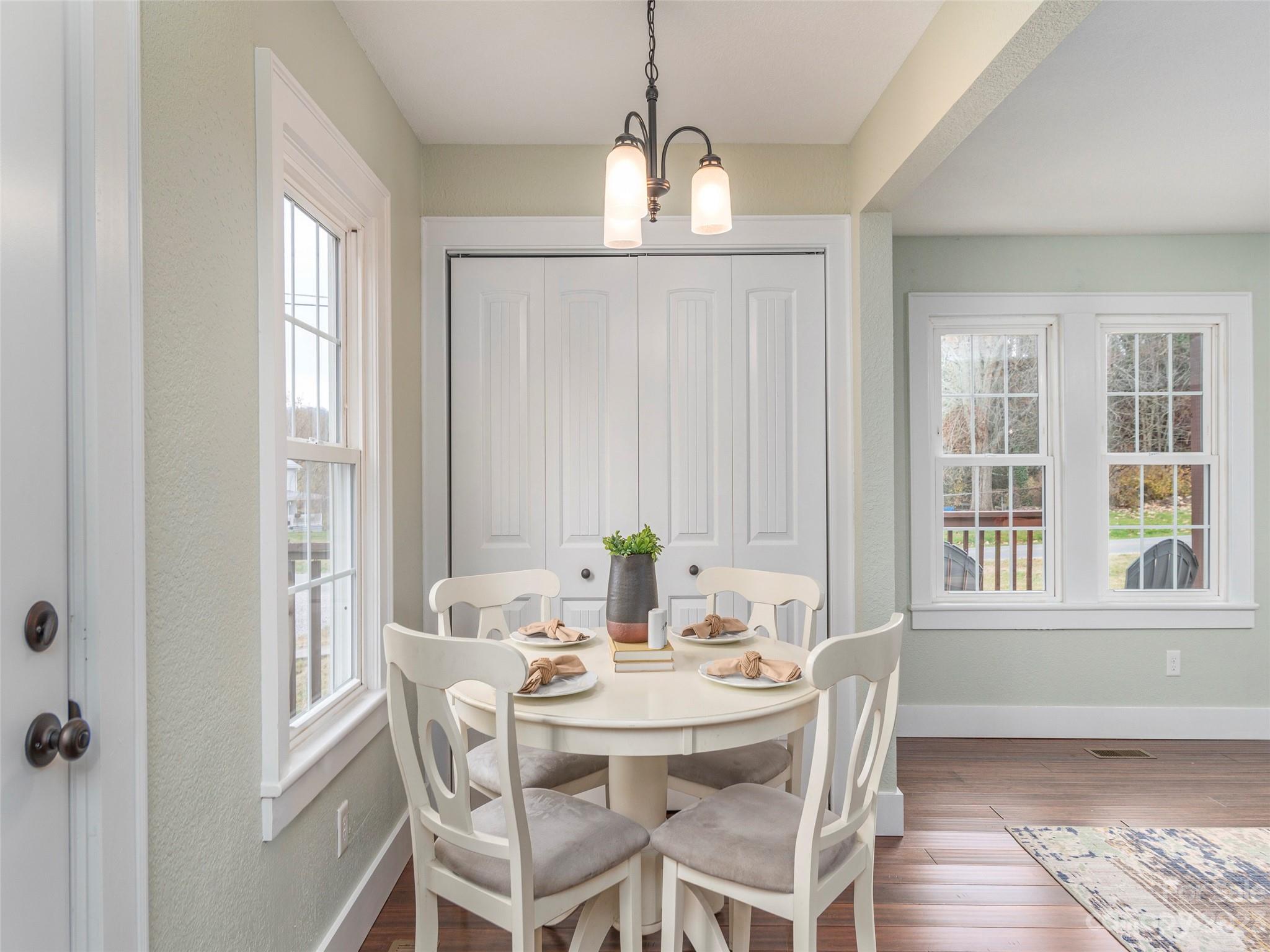 2117 Old Clyde Road Clyde, NC 28721 - Photo 14 of 24 a view of a dining room with furniture window and wooden floor