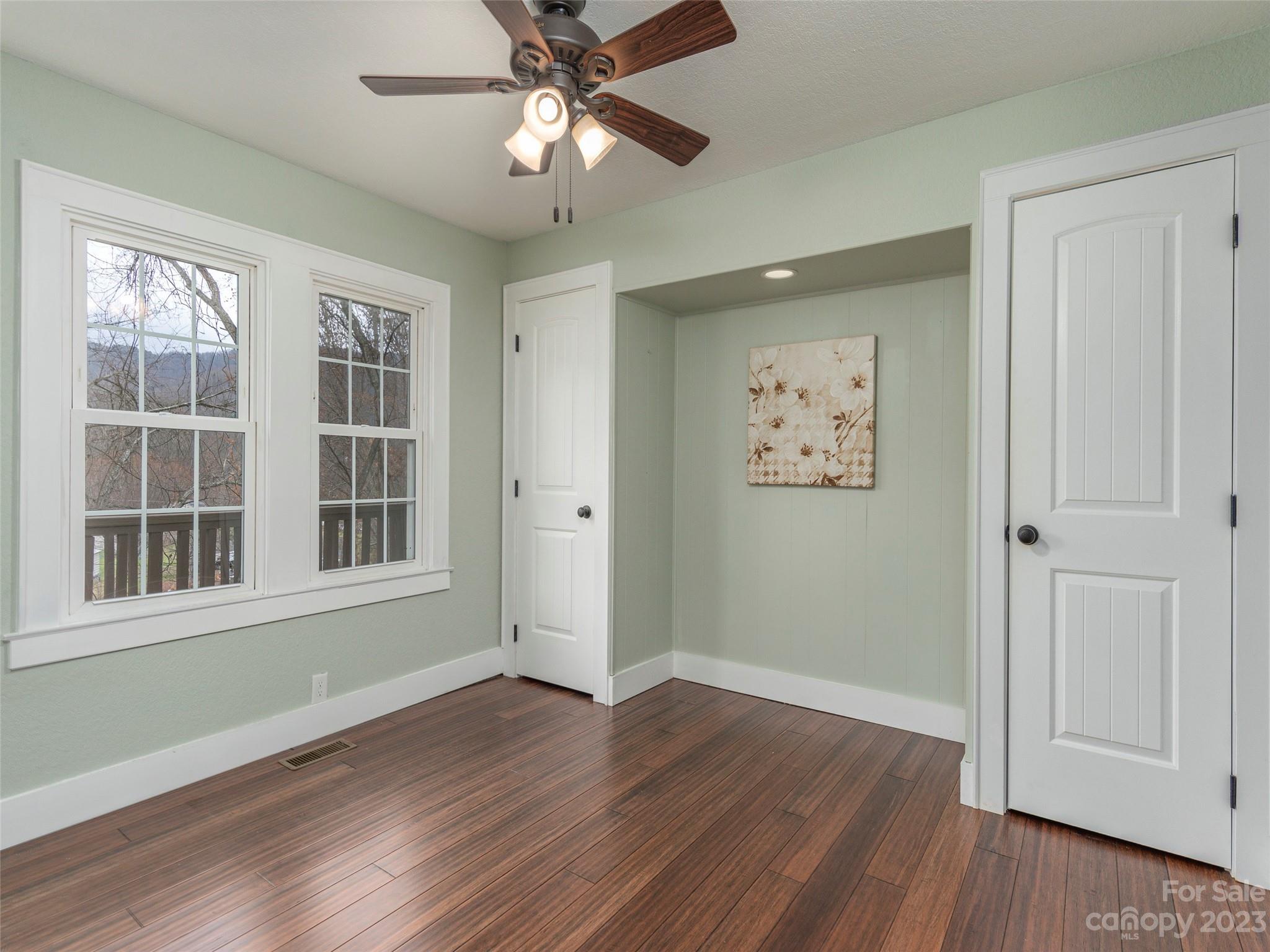 2117 Old Clyde Road Clyde, NC 28721 - Photo 17 of 24 a view of an empty room with wooden floor and a window