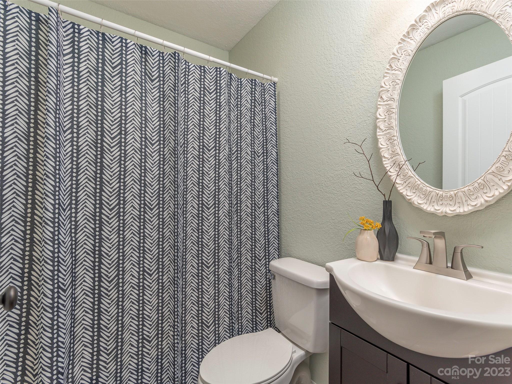 2117 Old Clyde Road Clyde, NC 28721 - Photo 18 of 24 a white toilet sitting next to a bathroom sink