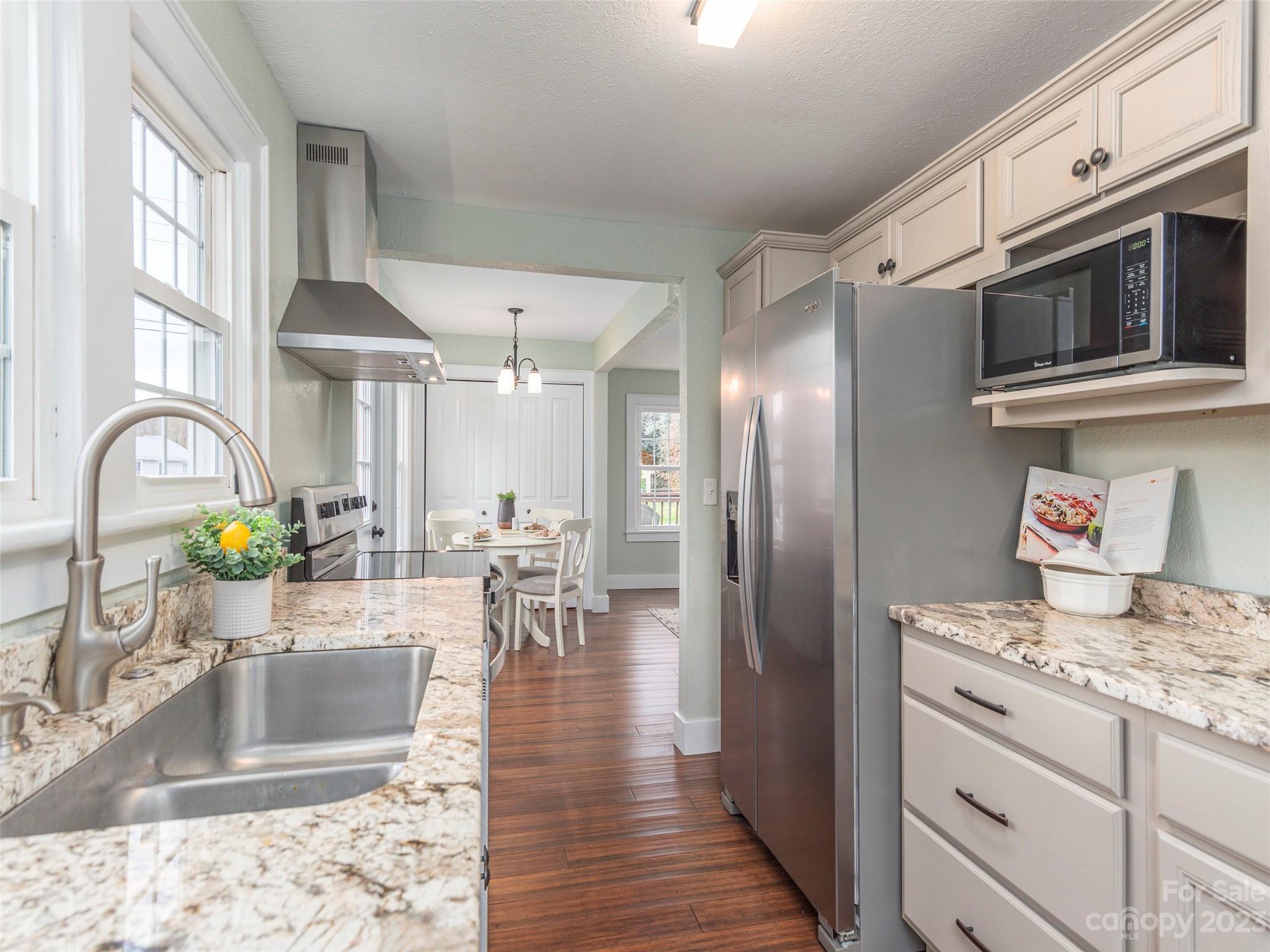 2117 Old Clyde Road Clyde, NC 28721 - Photo 2 of 24 a kitchen with stainless steel appliances granite countertop a stove a sink and a refrigerator