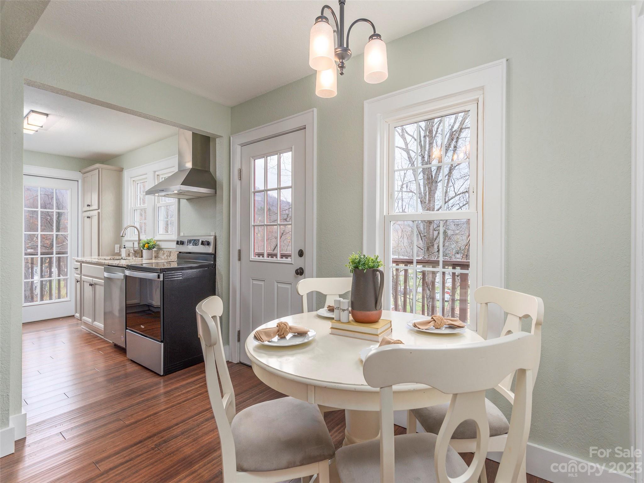 2117 Old Clyde Road Clyde, NC 28721 - Photo 3 of 24 a view of a dining room with furniture window and wooden floor
