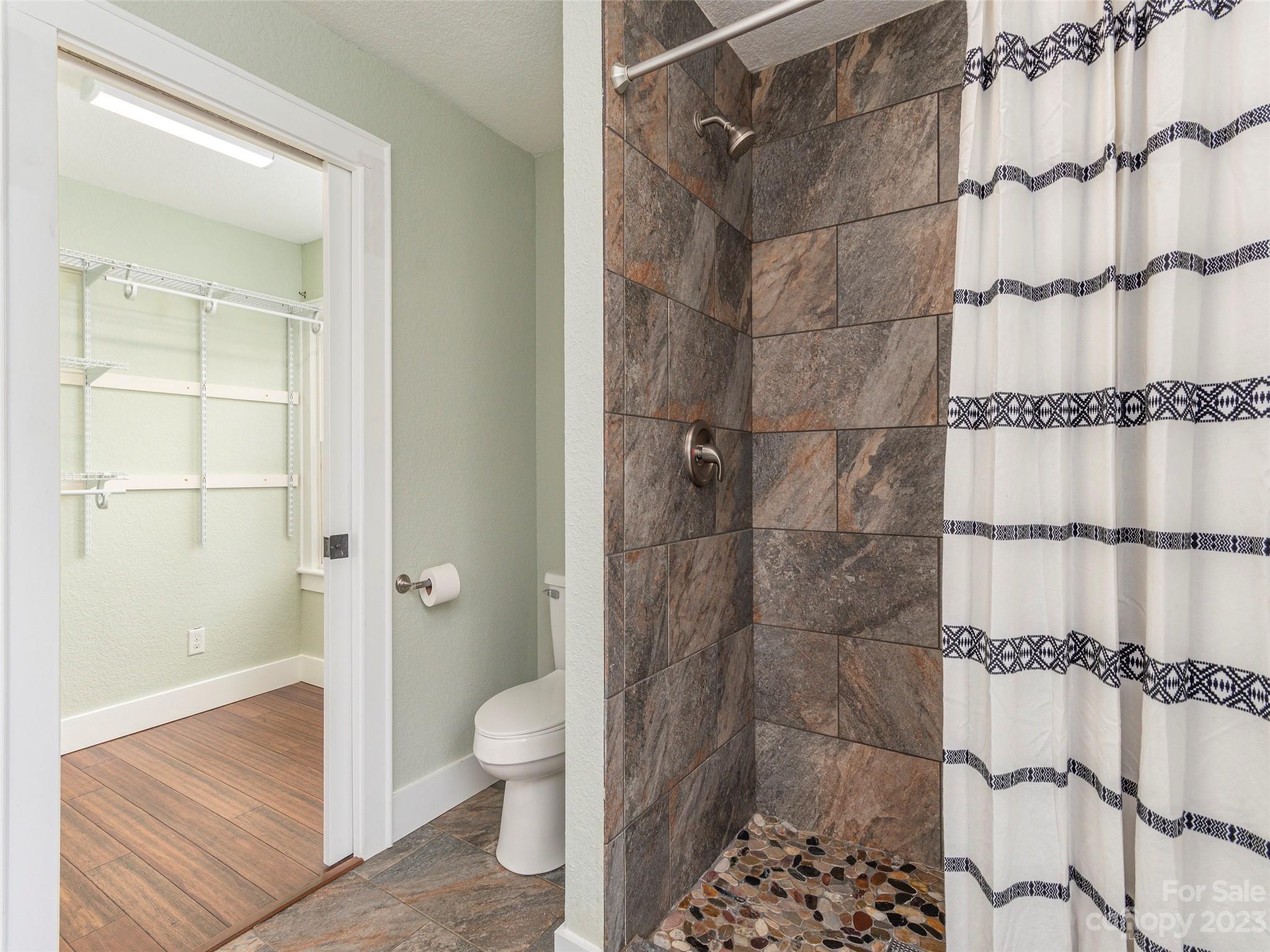 2117 Old Clyde Road Clyde, NC 28721 - Photo 6 of 24 a bathroom with a glass shower door