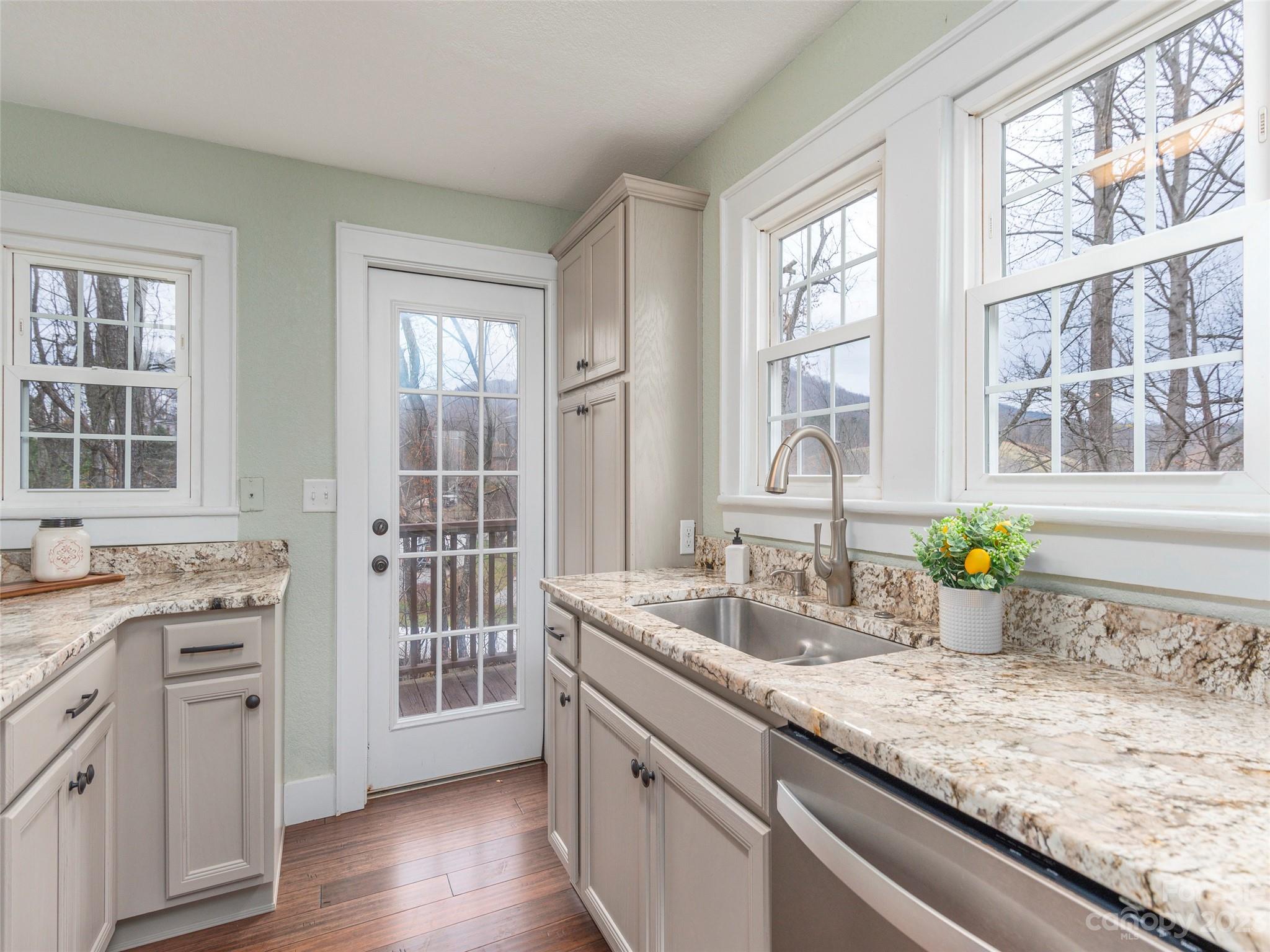 2117 Old Clyde Road Clyde, NC 28721 - Photo 10 of 24 a kitchen with sink cabinets and wooden floor