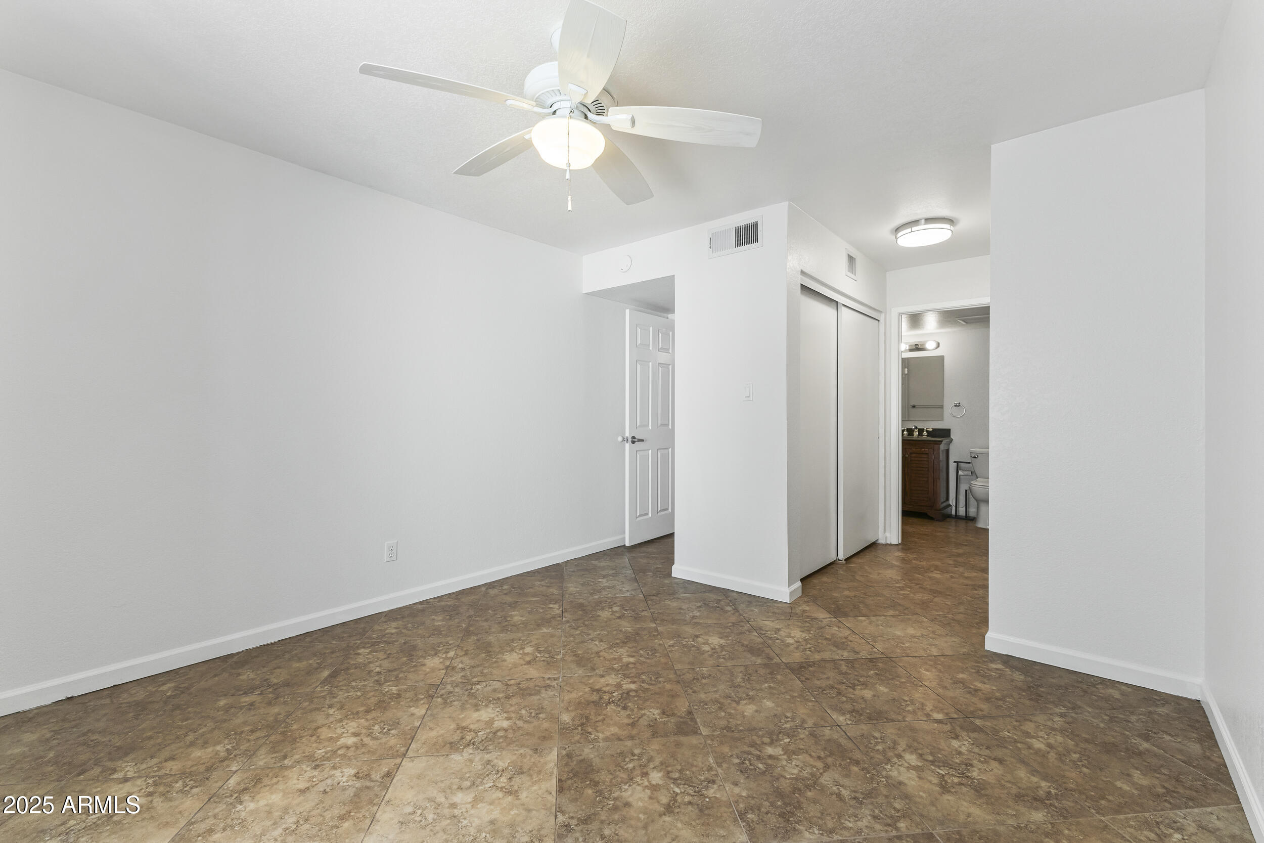 4730 West Northern Avenue, Unit 1158 Glendale, AZ 85301 - Photo 11 of 23 an empty room with a ceiling fan and a window