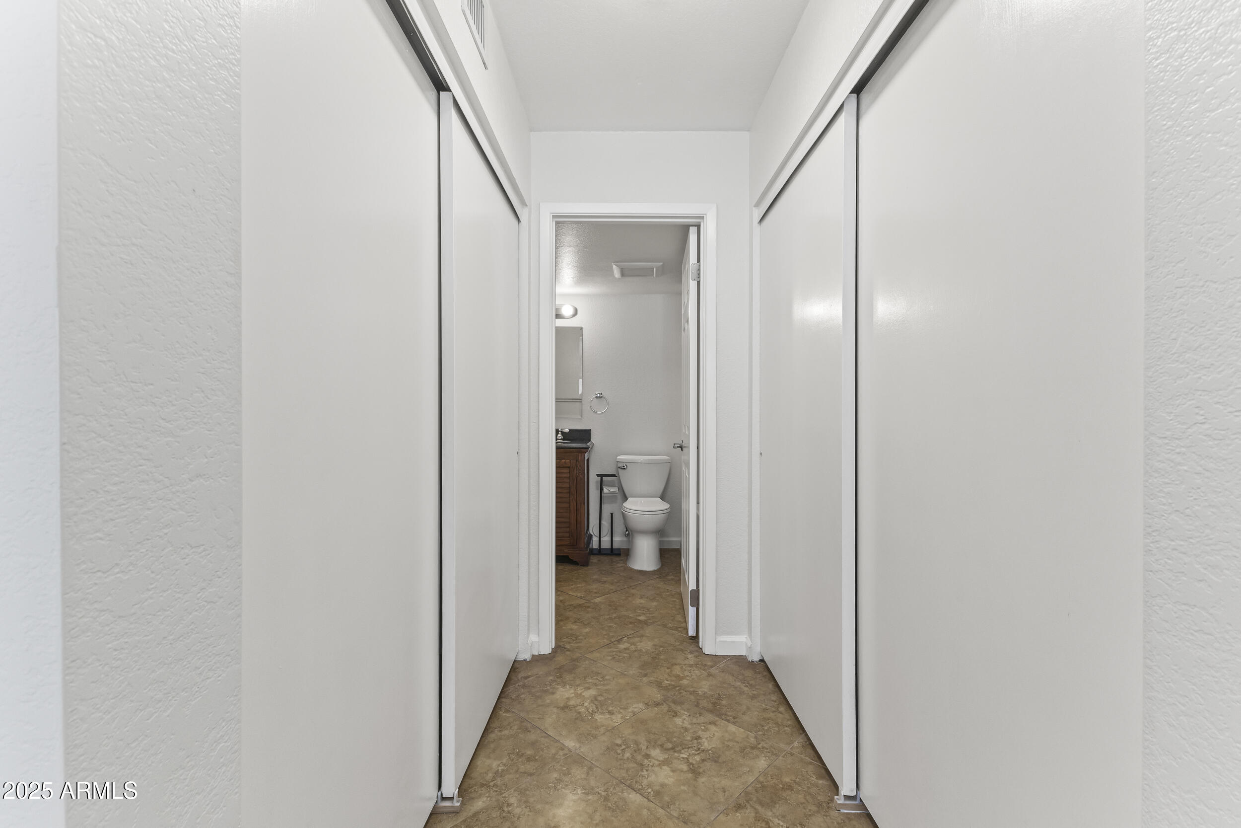 4730 West Northern Avenue, Unit 1158 Glendale, AZ 85301 - Photo 12 of 23 a view of a hallway with wooden shelves