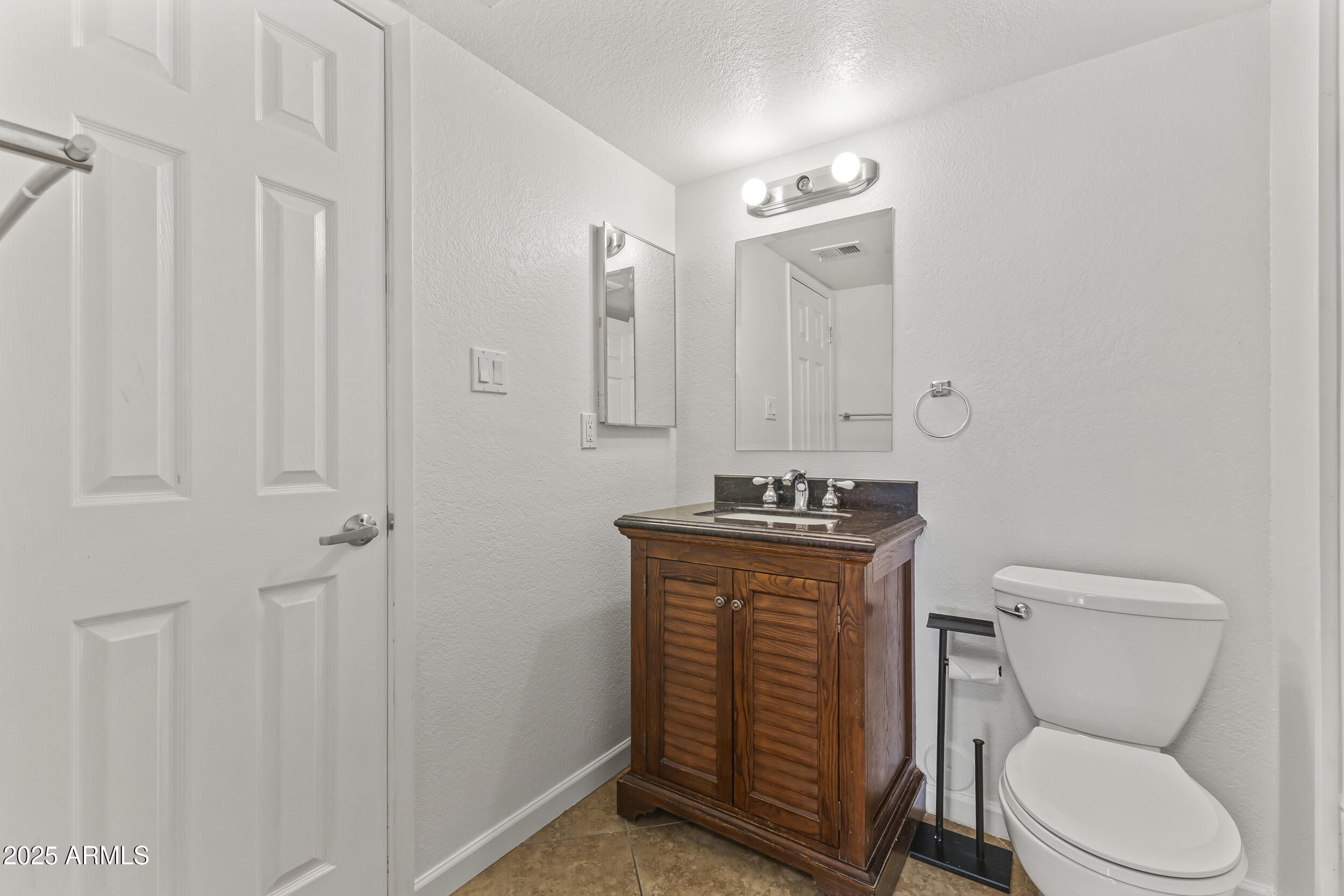 4730 West Northern Avenue, Unit 1158 Glendale, AZ 85301 - Photo 13 of 23 a bathroom with a toilet a sink and mirror