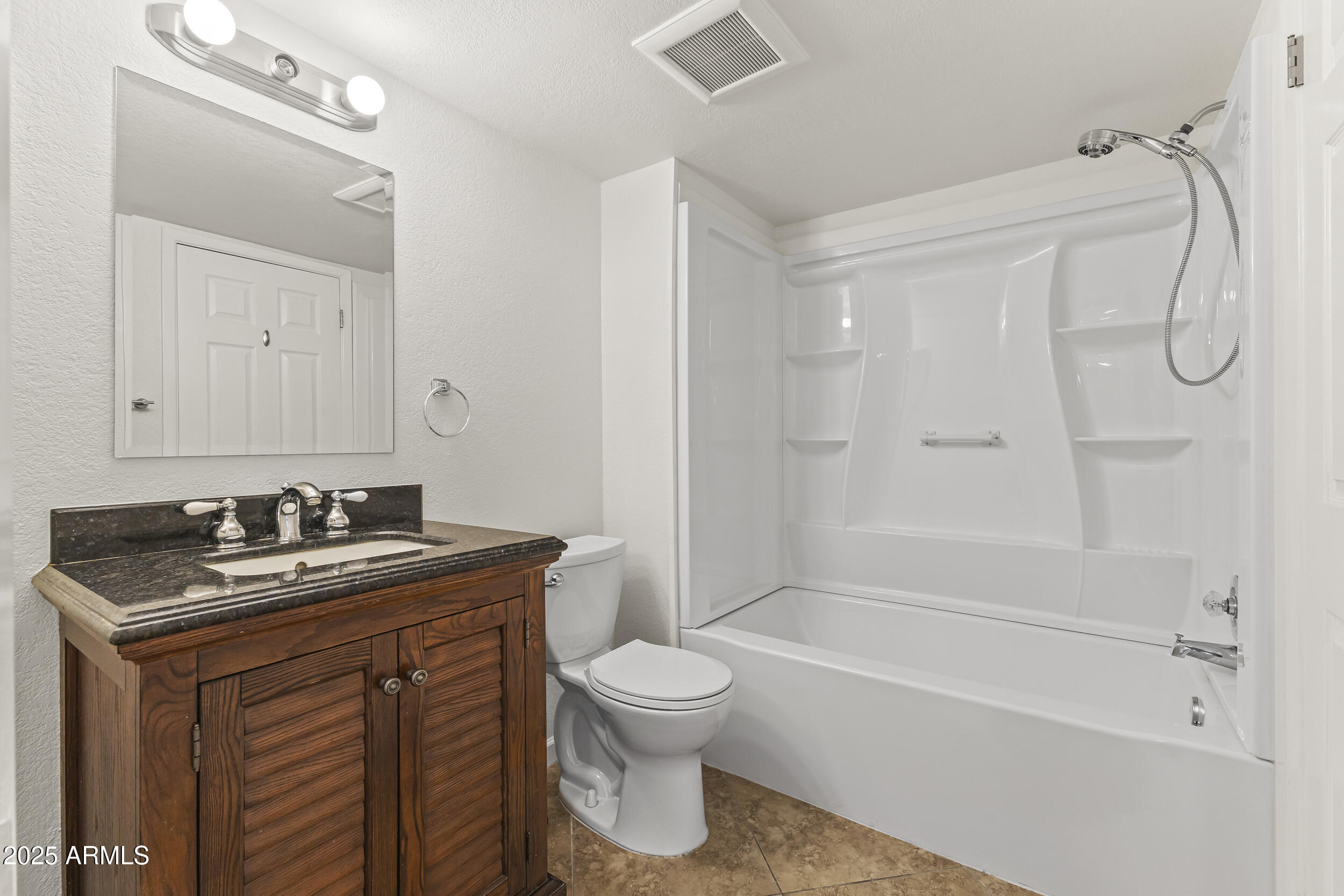 4730 West Northern Avenue, Unit 1158 Glendale, AZ 85301 - Photo 14 of 23 a bathroom with a granite countertop sink a toilet and a bathtub