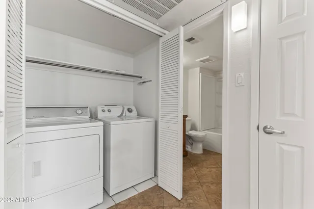 a view of bathroom with a washer and dryer