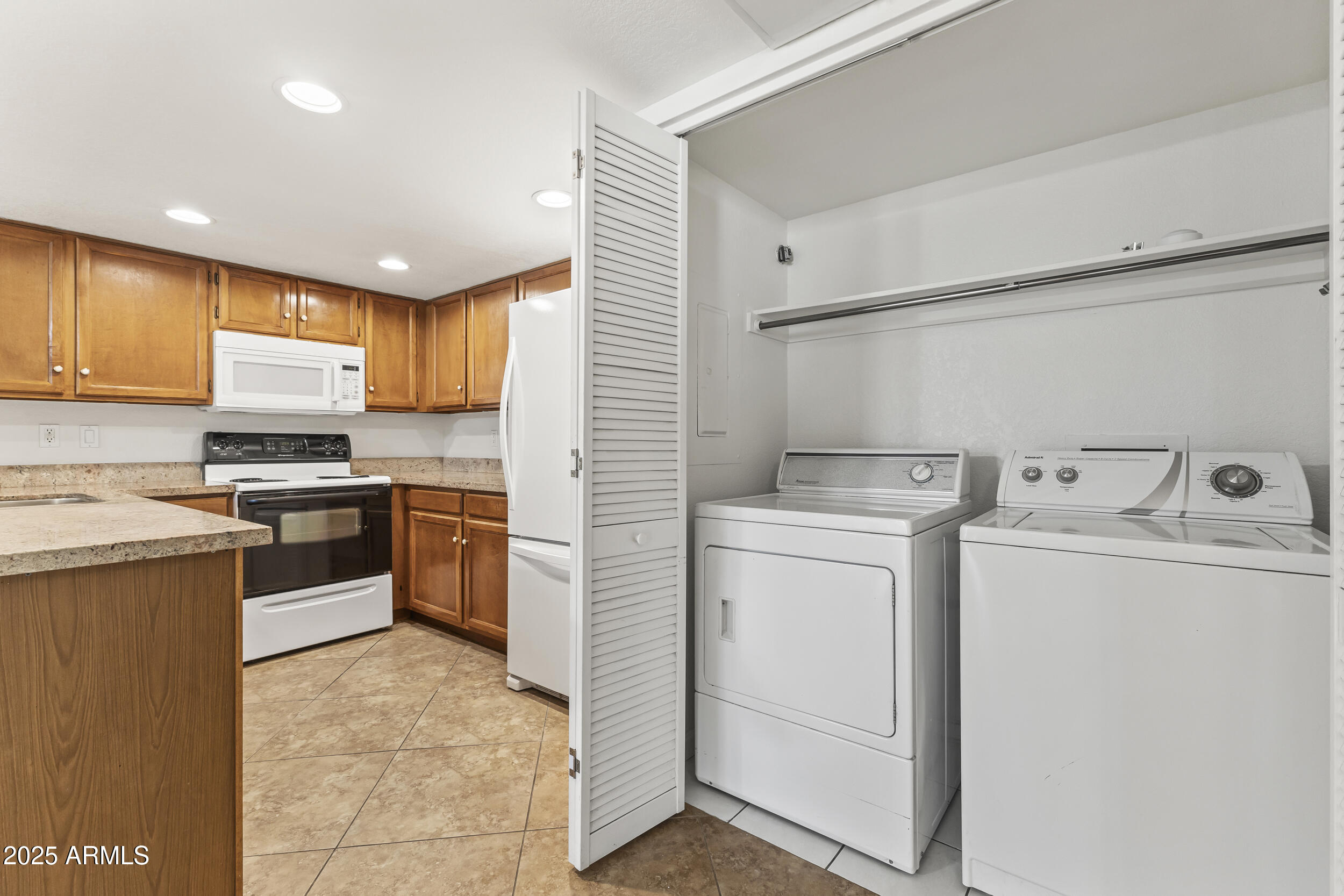 4730 West Northern Avenue, Unit 1158 Glendale, AZ 85301 - Photo 16 of 23 a kitchen with a sink a stove and cabinets