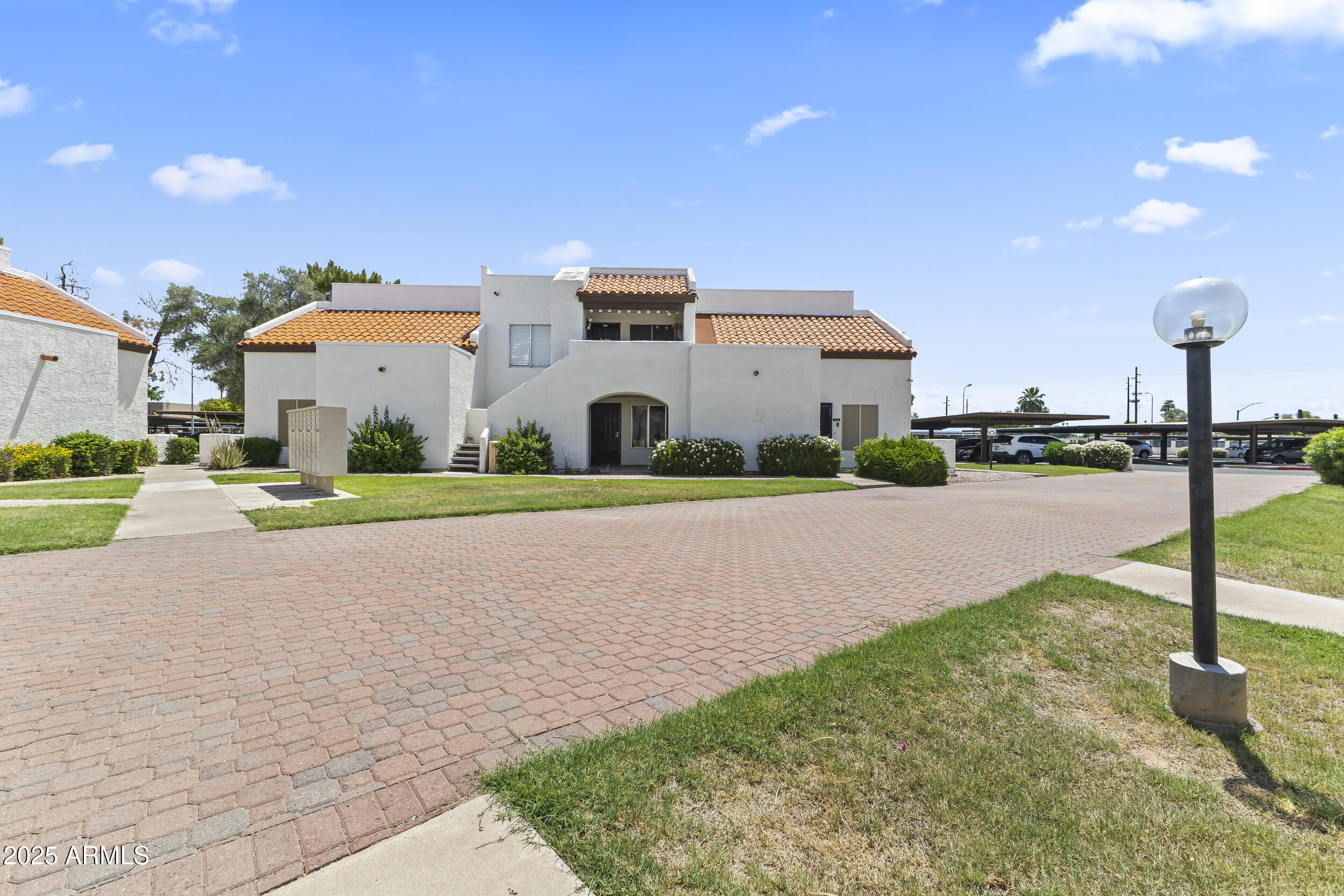 4730 West Northern Avenue, Unit 1158 Glendale, AZ 85301 - Photo 19 of 23 a front view of house with yard and green space
