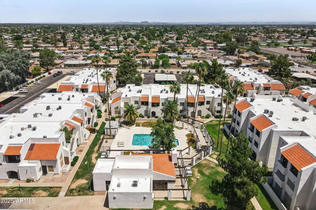 an aerial view of residential houses with outdoor space