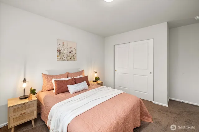 a bedroom with a bed and a painting on the wall