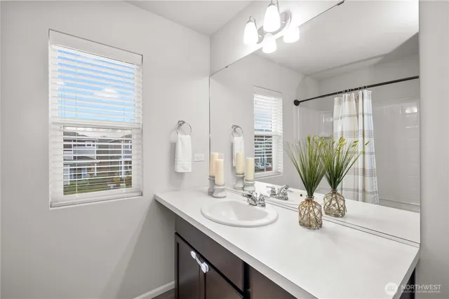a view of a bathroom with a sink and a mirror