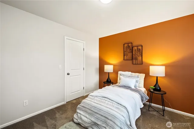 a bedroom with a bed and a lamp