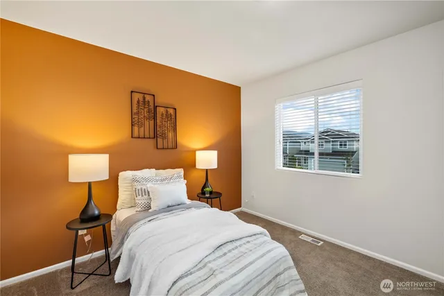 a bedroom with a bed and a lamp