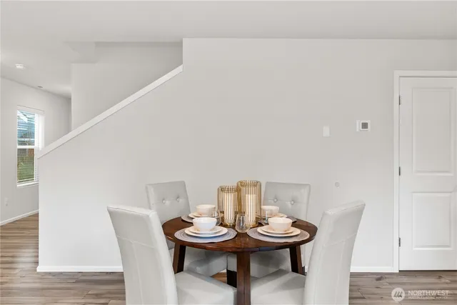 a view of a dining room with furniture and wooden floor