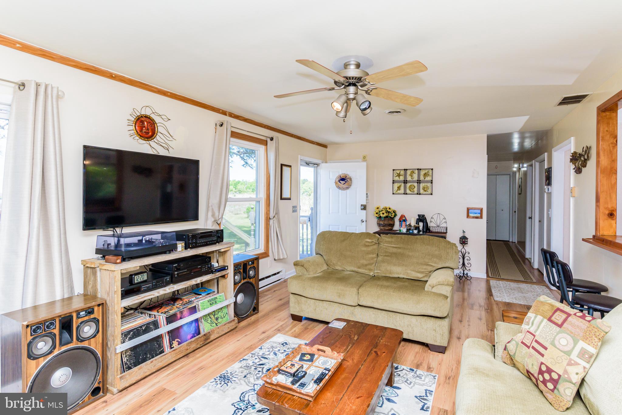 23212 Haines Point Road Chance, MD 21821 - Photo 27 of 57 a living room with furniture and a flat screen tv