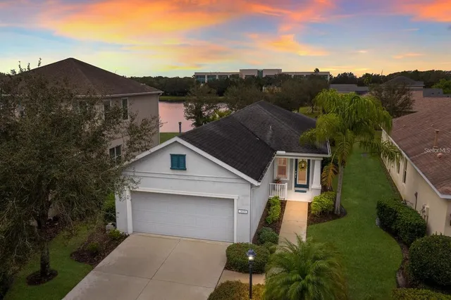an aerial view of a house with a yard and garage