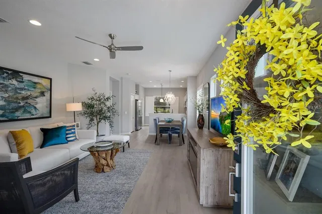 a living room with furniture and a chandelier