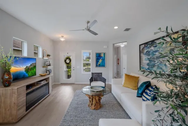 a bedroom with a bed a dresser and painting on the wall