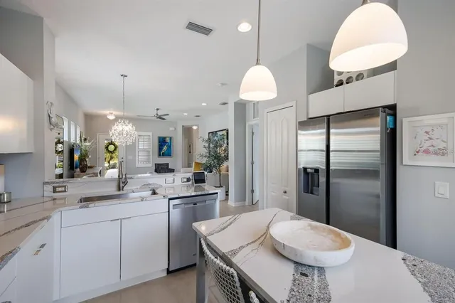 a living room with furniture a chandelier and a window