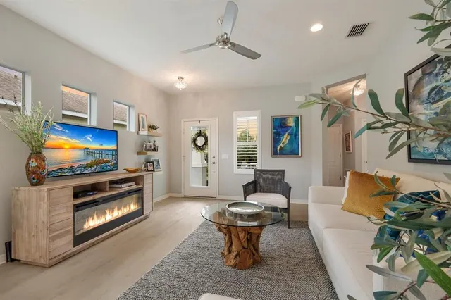 a living room with furniture a rug and a painting on the wall