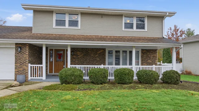 a view of a house with a yard and a large window