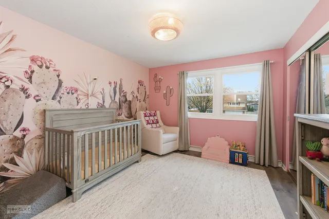 a bedroom with furniture and a large window