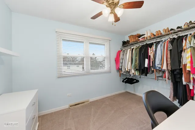 a view of walk in closet with clothes