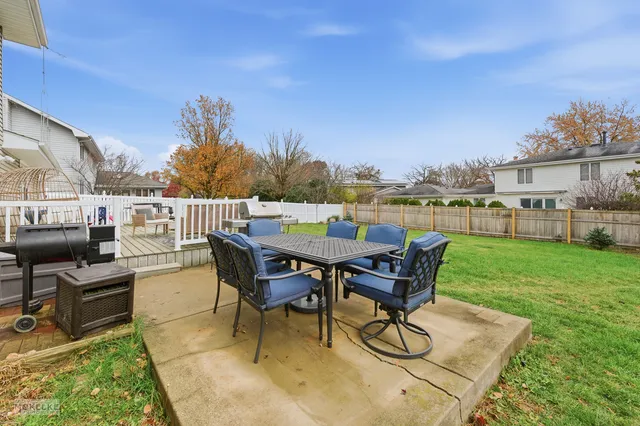 a view of a patio with table and chairs