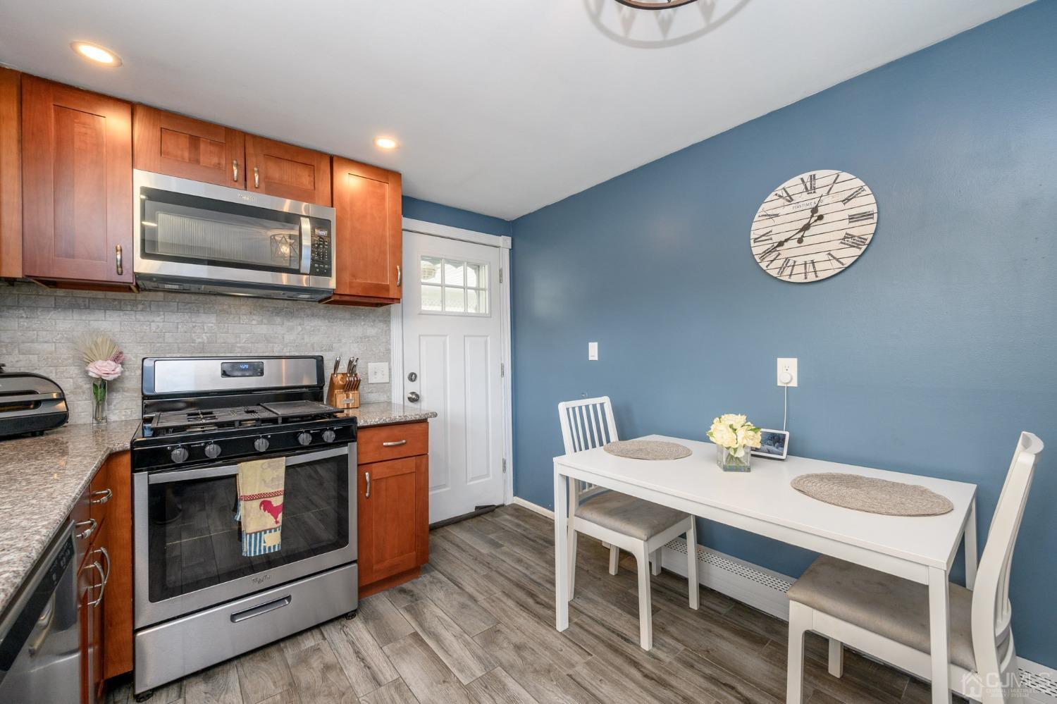 60 Ocean Boulevard Old Bridge, NJ 07735 - Photo 12 of 25 a kitchen with a stove a microwave and dining table