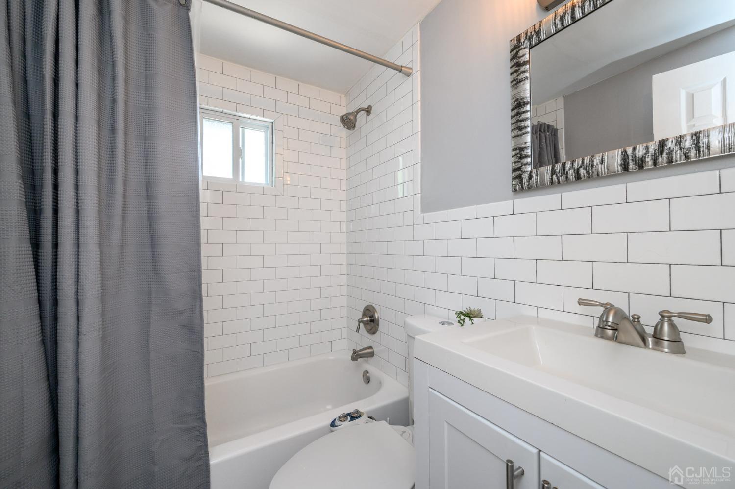 60 Ocean Boulevard Old Bridge, NJ 07735 - Photo 15 of 25 a bathroom with a sink a toilet and shower