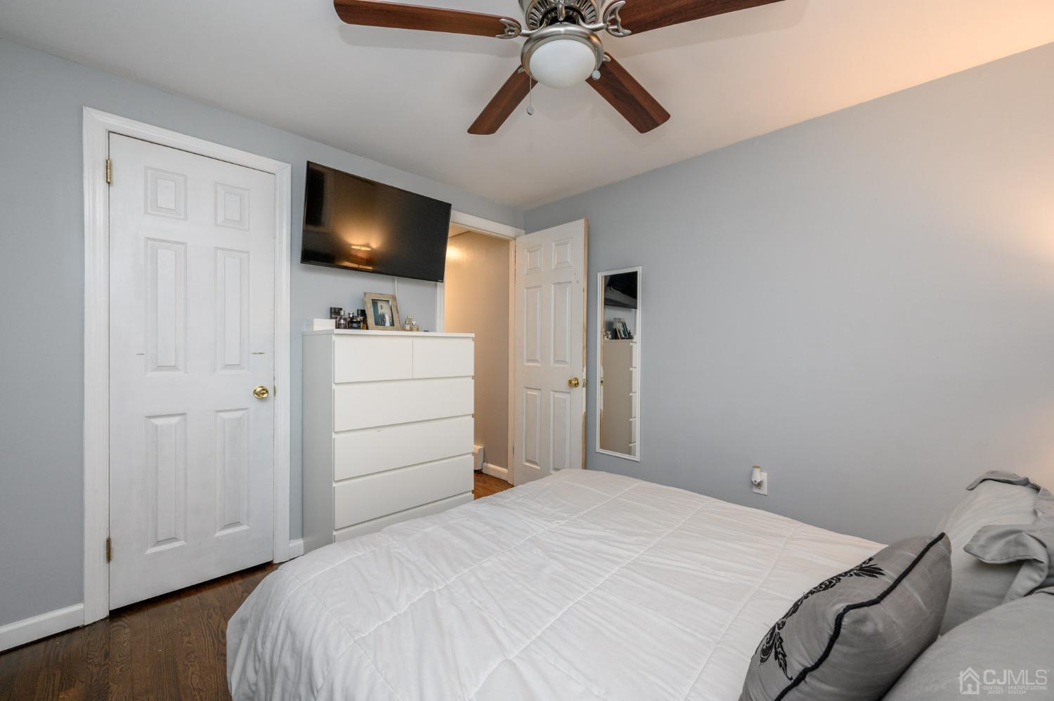 60 Ocean Boulevard Old Bridge, NJ 07735 - Photo 17 of 25 a bedroom with a bed and a flat screen tv