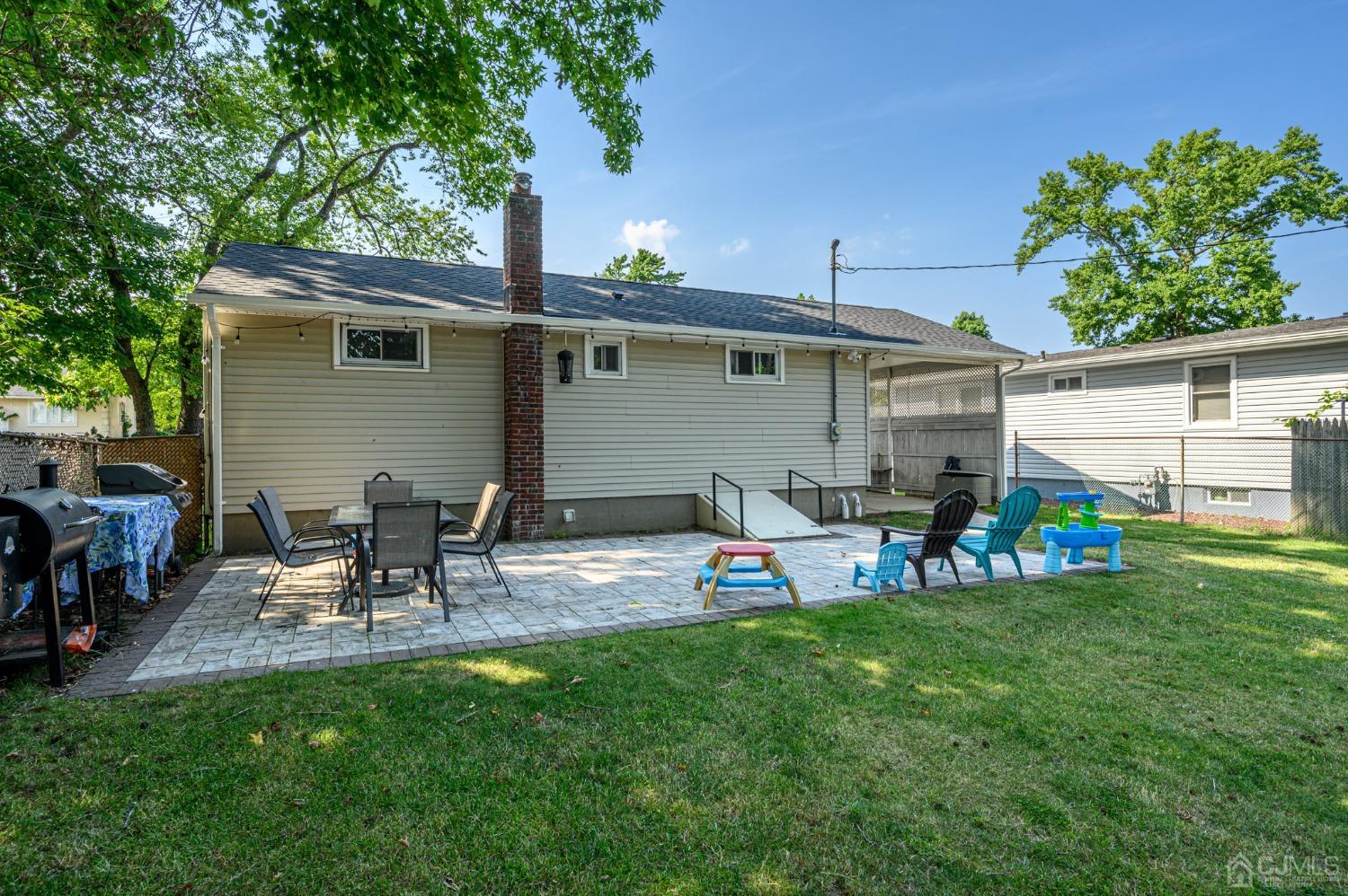 60 Ocean Boulevard Old Bridge, NJ 07735 - Photo 21 of 25 a view of a backyard with table and chairs
