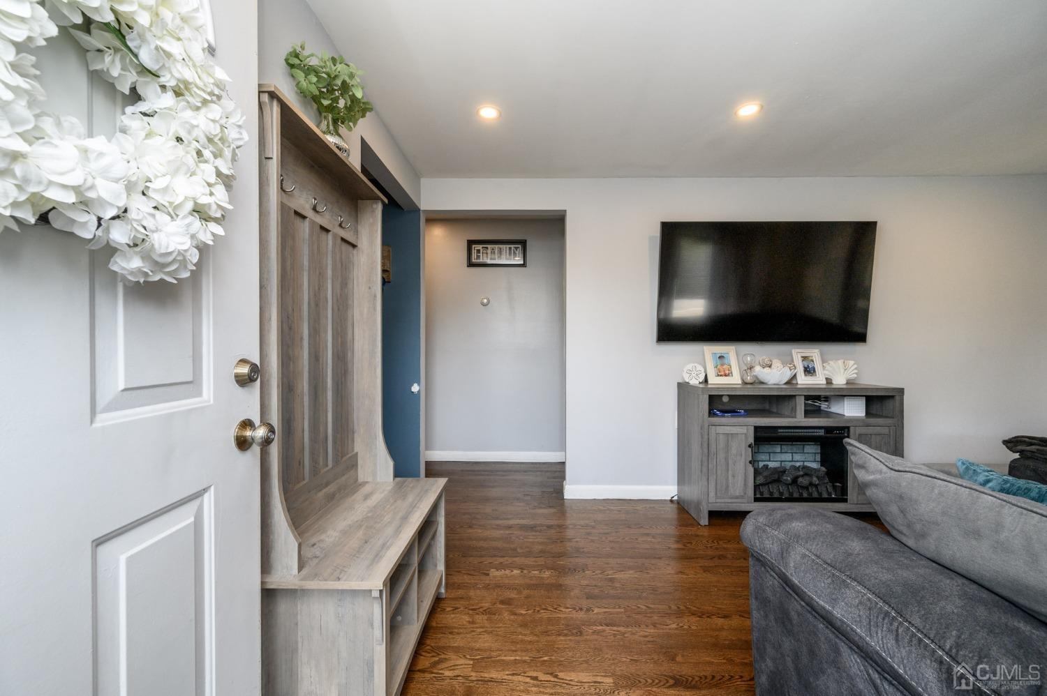 60 Ocean Boulevard Old Bridge, NJ 07735 - Photo 3 of 25 a living room with fireplace furniture and a flat screen tv