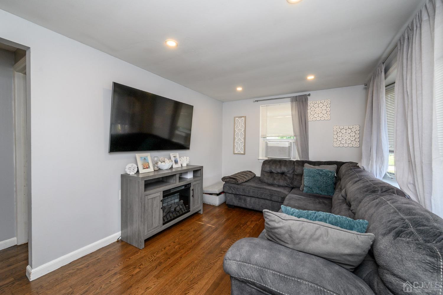 60 Ocean Boulevard Old Bridge, NJ 07735 - Photo 4 of 25 a living room with furniture and a flat screen tv