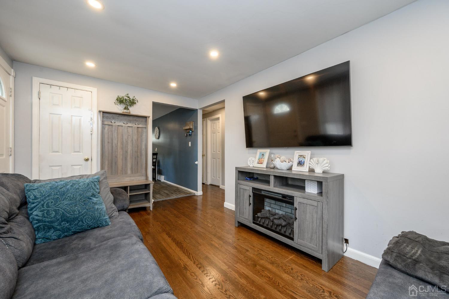 60 Ocean Boulevard Old Bridge, NJ 07735 - Photo 7 of 25 a living room with furniture and a flat screen tv