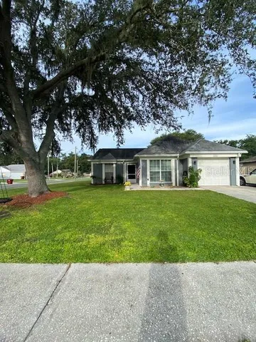 a front view of a house with a garden and yard