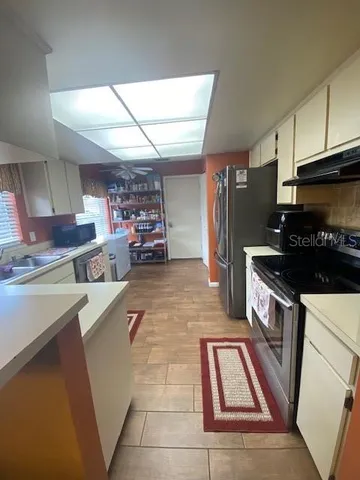 a kitchen with lots of counter top space and appliances