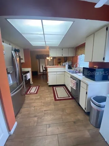 a kitchen with a sink a stove and cabinets
