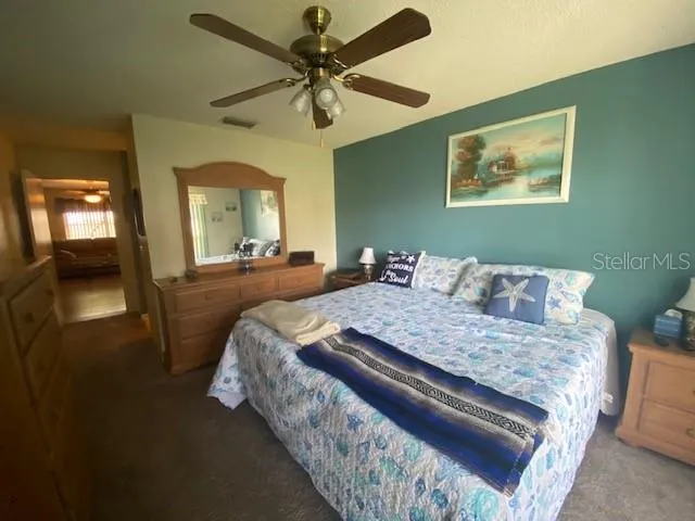 a bed sitting in a bedroom and a chandelier