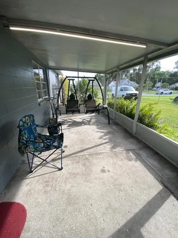 a swimming pool with outdoor seating and yard